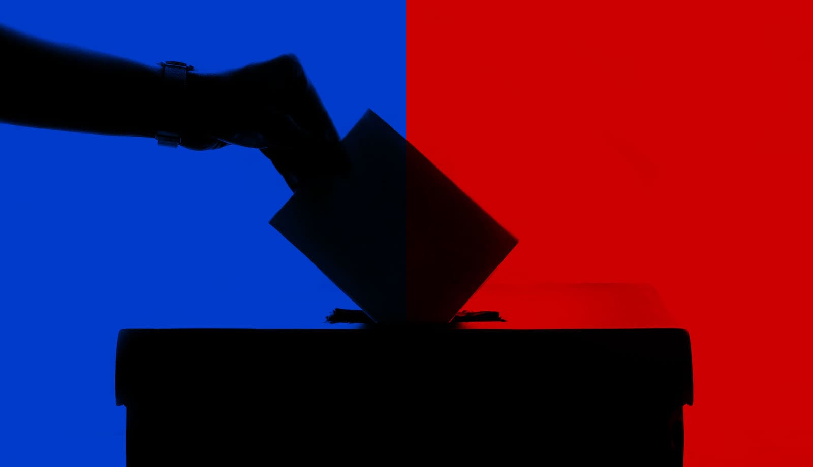 A hand dropping a ballot into a ballot box, behind a split blue and red background